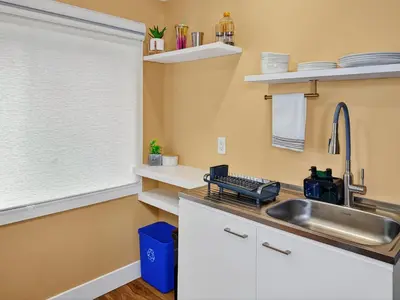 a kitchen with a sink and a window at Private Studio - 5 Min to DT - Self Check-In - 75 Inch TV in Williams Lake