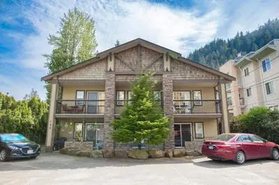 a house with two cars parked in front of it at Studio w Balcony with Smart TV and 2 Min Walk to Lake in Harrison Hot Springs