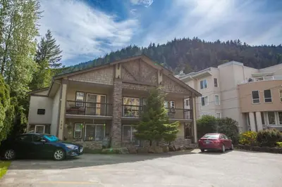 a house with two cars parked in a parking lot at RiversTail Retreat Pet-Friendly and Steps to The Lake in Harrison Hot Springs
