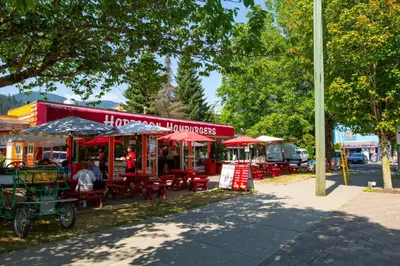 a group of tables and chairs in front of a store at The Backyard at Cedar Springs Walk to Lake and Hot Springs in Harrison Hot Springs