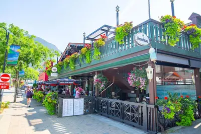 a street with a building with flowers and plants at The Backyard at Cedar Springs Walk to Lake and Hot Springs in Harrison Hot Springs