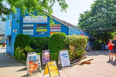 a building with signs on the side of it at Beachy 2 Bed Studio Suite, Balcony and 4 Min to Lake in Harrison Hot Springs