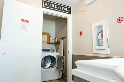 a laundry room with a washer and dryer at Beachy 2 Bed Studio Suite, Balcony and 4 Min to Lake in Harrison Hot Springs