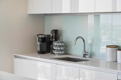 a kitchen counter with a sink and a coffee maker at The Getaway Next to Stampede 2BR Suite Downtown in Calgary