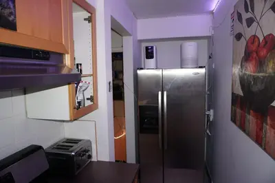 a kitchen with a stainless steel refrigerator in a room at Hotel Room 2 in Coquitlam