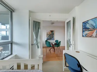 a living room with a table and chairs at Astoria Escape - Bright condo with work desk by Victoria Prime! in Victoria