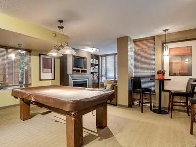a living room with a table and a dining room at Astoria Escape - Bright condo with work desk by Victoria Prime! in Victoria