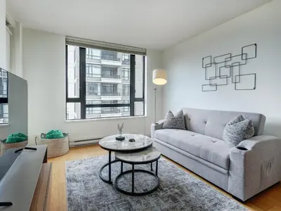 a living room with a couch and a table at Astoria Escape - Bright condo with work desk by Victoria Prime! in Victoria