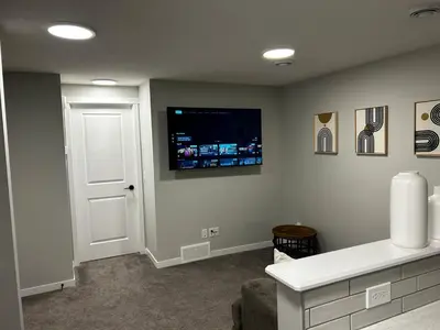 a living room with a television on the wall at Bright & Spacious 2BR Getaway in Calgary