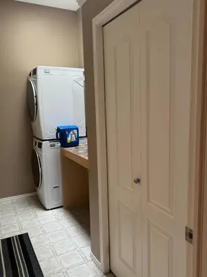 a kitchen with a white refrigerator and a counter at Heavenly Cozy Place Inc in Airdrie