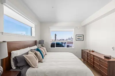 a bedroom with a large bed and a window at Sidney Sunnyside - Luxurious Seaside Living in Amazing Sidney by Victoria Prime! in Sidney