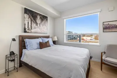 a bedroom with a large bed and a window at Sidney Sunnyside - Luxurious Seaside Living in Amazing Sidney by Victoria Prime! in Sidney