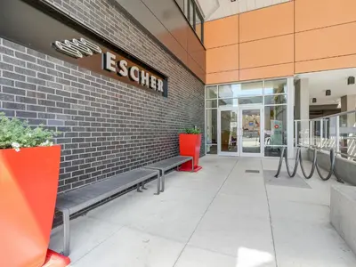 a building with a bench in front of a store at Sunset Place-Deluxe One Bedroom Condo in the Escher Building, Sunset Views and Beyond in Victoria