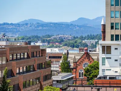 a view of a city with buildings and a church at Sunset Place-Deluxe One Bedroom Condo in the Escher Building, Sunset Views and Beyond in Victoria