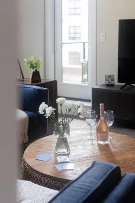 a table with a vase of flowers and wine glasses at Riverstone Retreat in Golden BC in Golden