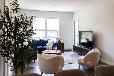 a living room with a couch and a tv at Riverstone Retreat in Golden BC in Golden