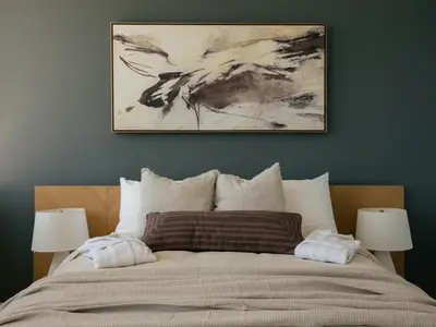 a bedroom with a bed with a painting above it at Bialto Bed and Breakfast in Penticton