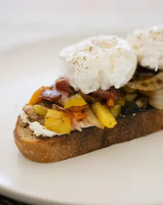 a sandwich with an egg on a white plate at Bialto Bed and Breakfast in Penticton