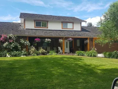 a house with a lawn in front of it at Just across from the lake ! in Kelowna