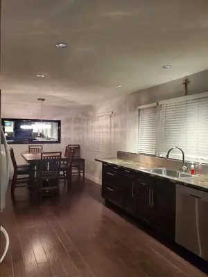 a kitchen with a sink and a table with chairs at Just across from the lake ! in Kelowna