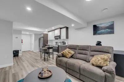a living room with a couch and a table at TheCozyNest in Calgary