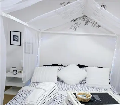 a white room with a bed with a canopy at Charming Beautiful Private Room With Private Bath and Parking! Near Metrotown in Burnaby