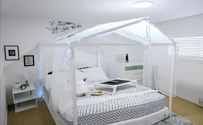 a white bed with a canopy in a room at Charming Beautiful Private Room With Private Bath and Parking! Near Metrotown in Burnaby