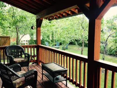 a screened in porch with two chairs and a table at Luna Bed & Breakfast in Grand Forks
