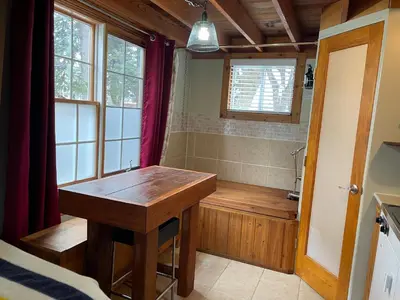 a bathroom with a wooden table and a tub at Luna Bed & Breakfast in Grand Forks