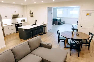 a kitchen and living room with a couch and a table at Revy To Go - Unique 2-Bedroom Condo in Revelstoke