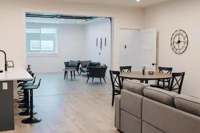 a waiting room with a table and chairs and a clock at Revy To Go - Unique 2-Bedroom Condo in Revelstoke
