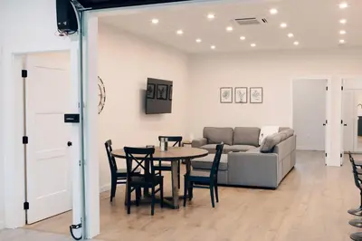 a living room with a table and a couch at Revy To Go - Unique 2-Bedroom Condo in Revelstoke