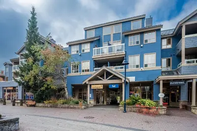 a blue building on a street in a city at 1BR plus King Murphy Bed in Tyndall Stone Lodge, Village Location, Pool and Hot Tub, Fireplace in Whistler