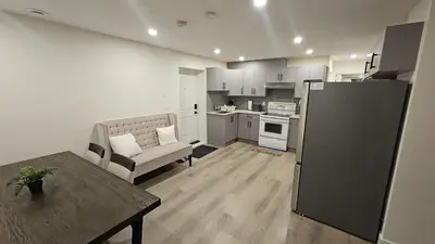 a kitchen and living room with a couch and a table at Your Home - Spacious Private Suite in Delta