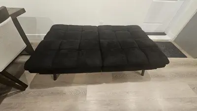 a black couch sitting in a living room at Your Home - Spacious Private Suite in Delta