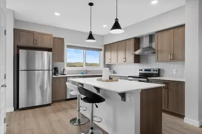 a kitchen with wooden cabinets and a white counter top at Spacious 3-Bedroom Vacation Home in Calgary with Free Parking in Calgary