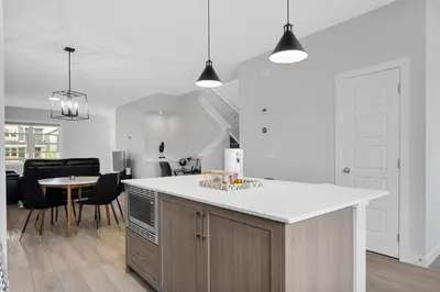 a kitchen with a white counter top and a table at Spacious 3-Bedroom Vacation Home in Calgary with Free Parking in Calgary