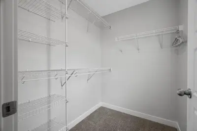 a walk in shower with glass shelves in a room at Spacious 3-Bedroom Vacation Home in Calgary with Free Parking in Calgary