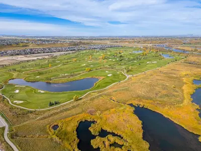 an aerial view of a golf course with two lakes at Spacious 3-Bedroom Vacation Home in Calgary with Free Parking in Calgary