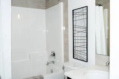 a bathroom with a sink and a tub and a toilet at Strawberry Fields 4BD Family Movie Room Office in Calgary