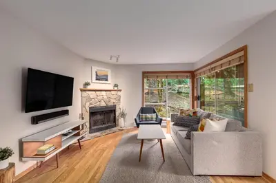 a living room with a couch and a fireplace at 1BR in Powderview, Creekside, Bright and Cozy, Private Ski Storage, Fireplace, Free Parking in Whistler