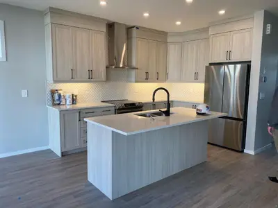 a kitchen with a large island in the middle at Cozy House In Airdrie in Airdrie
