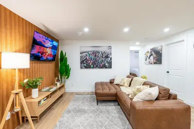 a living room with a couch and a table at Free Parking - Beautyrest Beds - Heated Bath Floor in Calgary