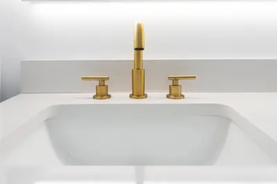 a bathroom sink with two faucets on it at The Pines on 15th Ave - Hot Tub, BBQ in Invermere