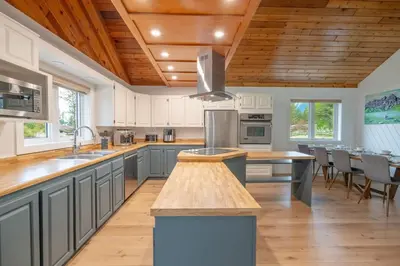 a large kitchen with wooden ceilings and wooden counters at The Pines on 15th Ave - Hot Tub, BBQ in Invermere