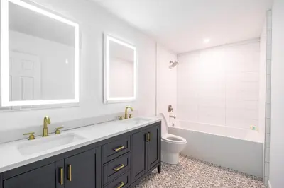 a bathroom with a sink and a tub and a toilet at The Pines on 15th Ave - Hot Tub, BBQ in Invermere