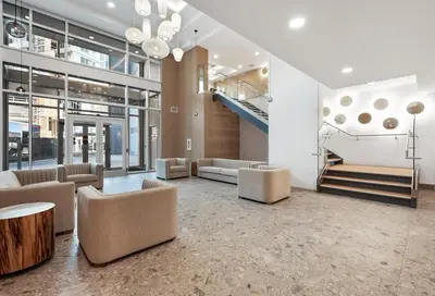 a lobby with couches and a staircase in a building at AQUA Corner Unit w Balcony and Amazing View #614 in Kelowna