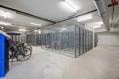 a room with a bunch of cages with bikes in it at AQUA Corner Unit w Balcony and Amazing View #614 in Kelowna