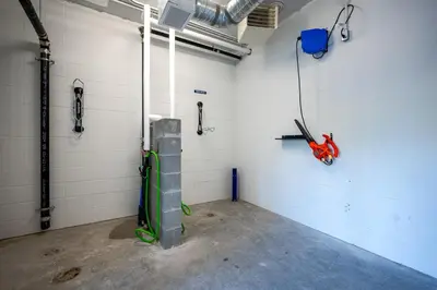 a garage with a room with a red motorcycle in it at AQUA Corner Unit w Balcony and Amazing View #614 in Kelowna
