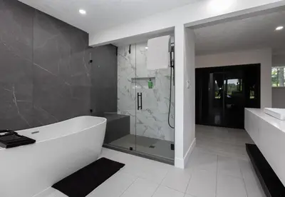 a bathroom with a bath tub and a shower at Modern 5BR Luxury Getaway in Cobble Hill